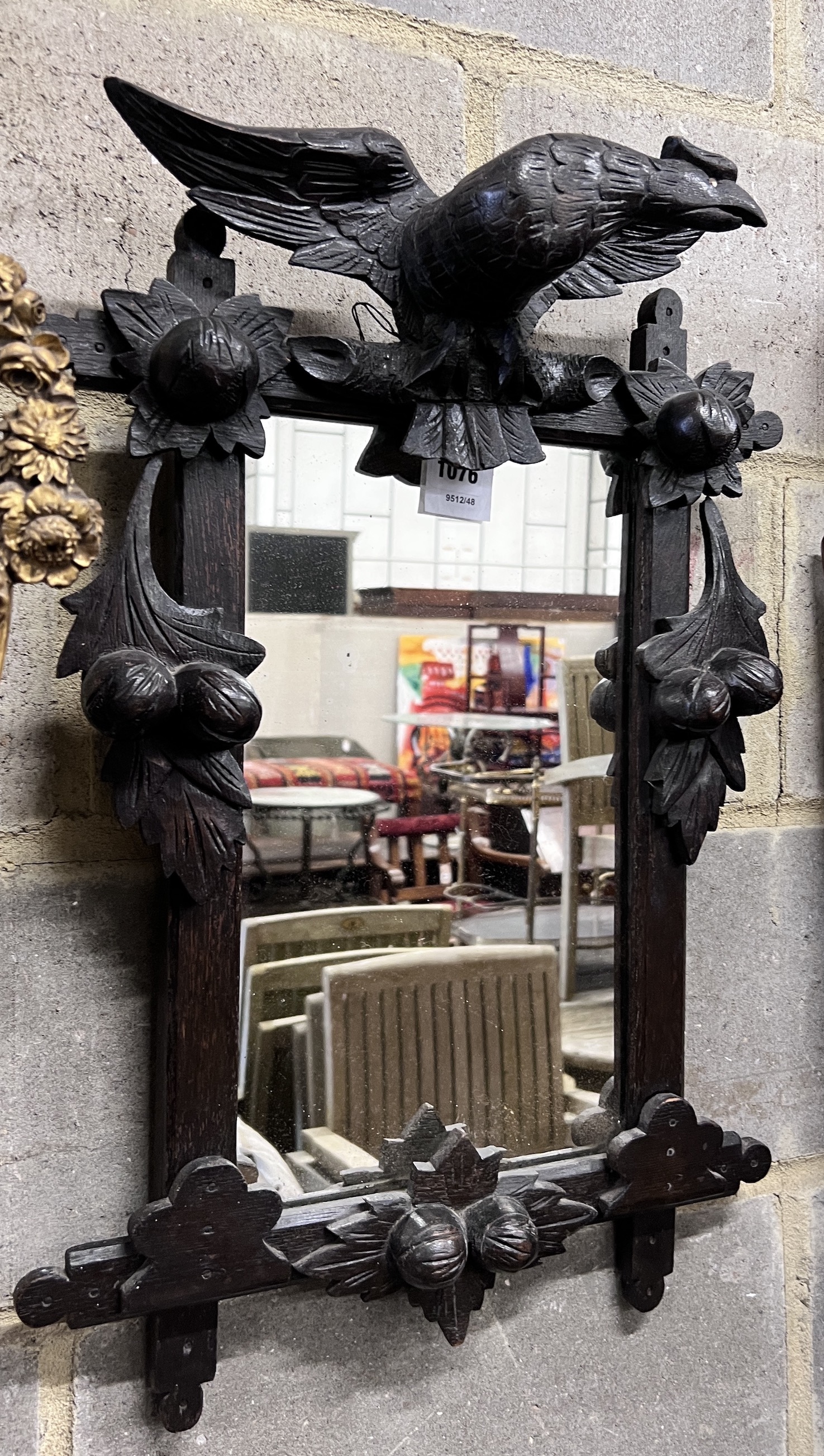 A late 19th century Black Forest ebonised oak wall mirror with eagle surmount, width 46cm, height 65cm